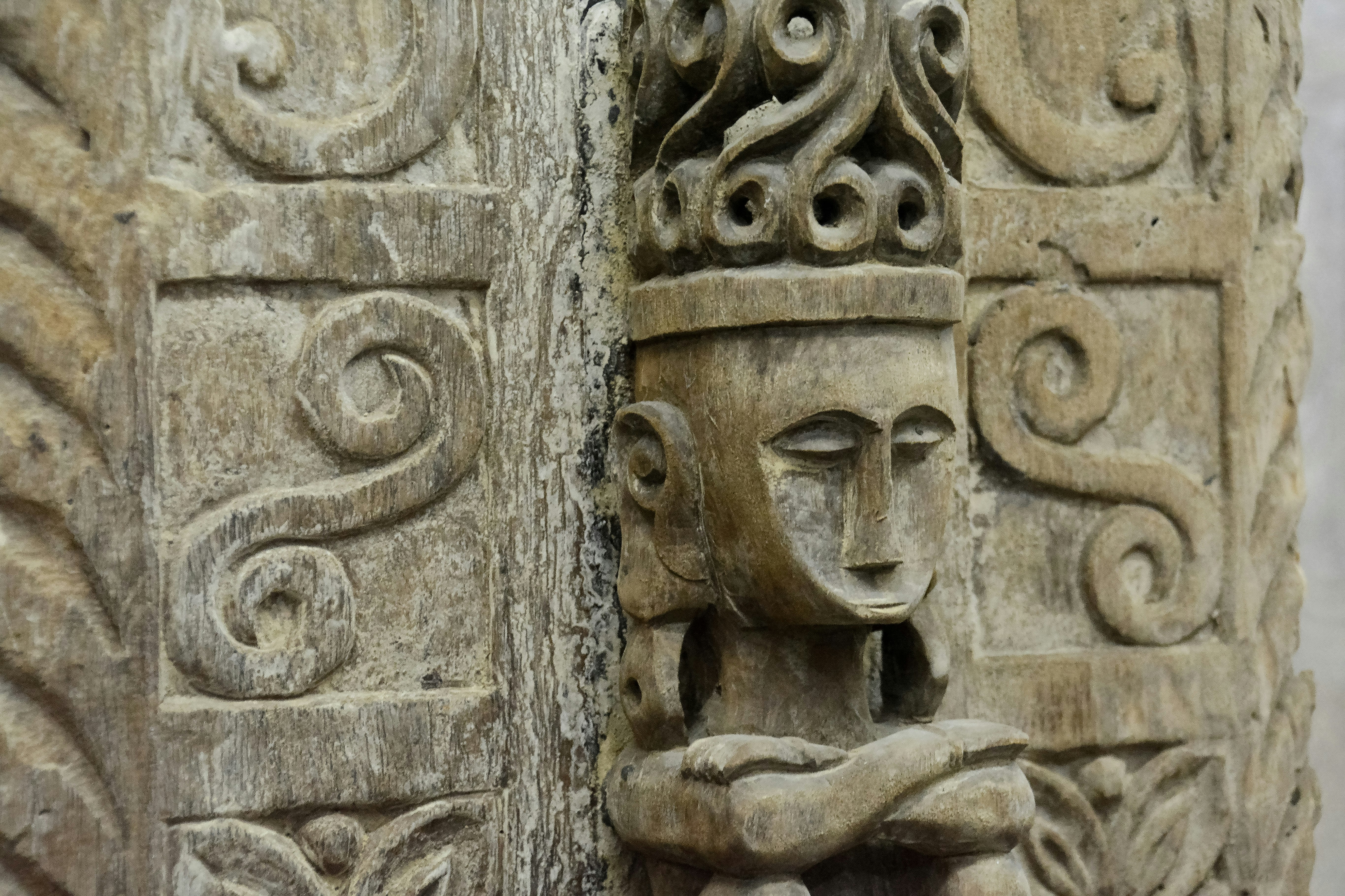 brown concrete wall with human face carved